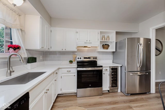 49 Druid Hill Ct Unit 0, Carmel, IN 46032 - kitchen featuring stainless steel appliances, beverage cooler, under cabinet range hood, white cabinetry, and light wood-style floors