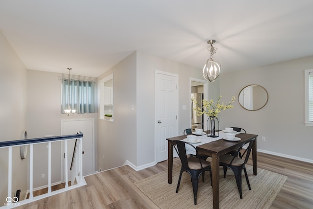 49 Druid Hill Ct Unit 0, Carmel, IN 46032 - dining area featuring a chandelier, light wood-style flooring, and plenty of natural light