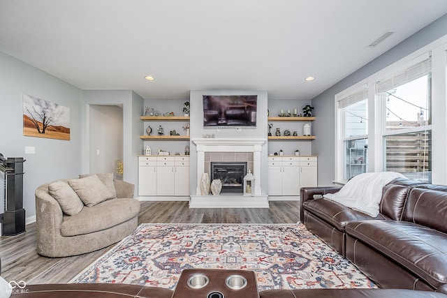 12634 Mustard Seed Ct, Fishers, IN 46038 - living room with wood finished floors, a tiled fireplace, and recessed lighting