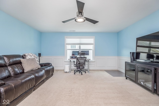 12634 Mustard Seed Ct, Fishers, IN 46038 - carpeted living area with a desk, a wainscoted wall, ceiling fan, and a decorative wall