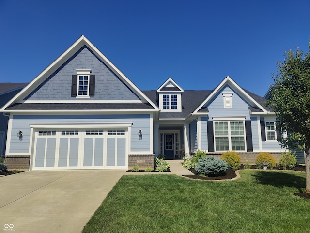 12634 Mustard Seed Ct, Fishers, IN 46038 - view of front facade with brick siding, driveway, a front lawn, and roof with shingles