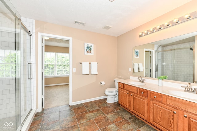 13700 Stanford Dr, Carmel, IN 46074 - bathroom with double vanity, a stall shower, and stone finish flooring