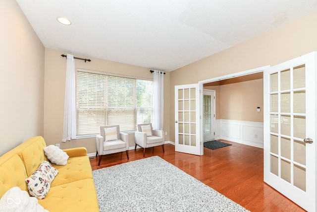 13700 Stanford Dr, Carmel, IN 46074 - sitting room with french doors, wood finished floors, recessed lighting, and a wainscoted wall