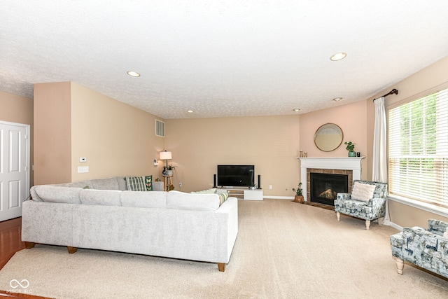 13700 Stanford Dr, Carmel, IN 46074 - living room featuring light carpet, a tiled fireplace, and recessed lighting