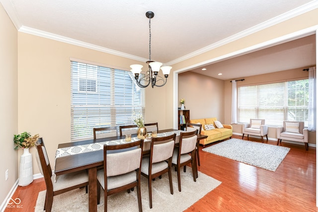13700 Stanford Dr, Carmel, IN 46074 - dining room featuring wood finished floors, ornamental molding, and a chandelier