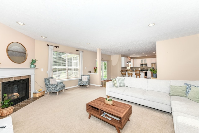 13700 Stanford Dr, Carmel, IN 46074 - living room featuring a tile fireplace, light carpet, and recessed lighting