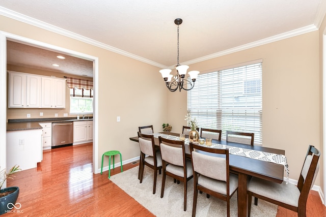 13700 Stanford Dr, Carmel, IN 46074 - dining area with crown molding, a chandelier, and light wood-style floors