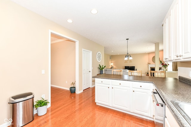 13700 Stanford Dr, Carmel, IN 46074 - kitchen with a peninsula, white cabinetry, light wood-style flooring, dishwasher, and decorative light fixtures