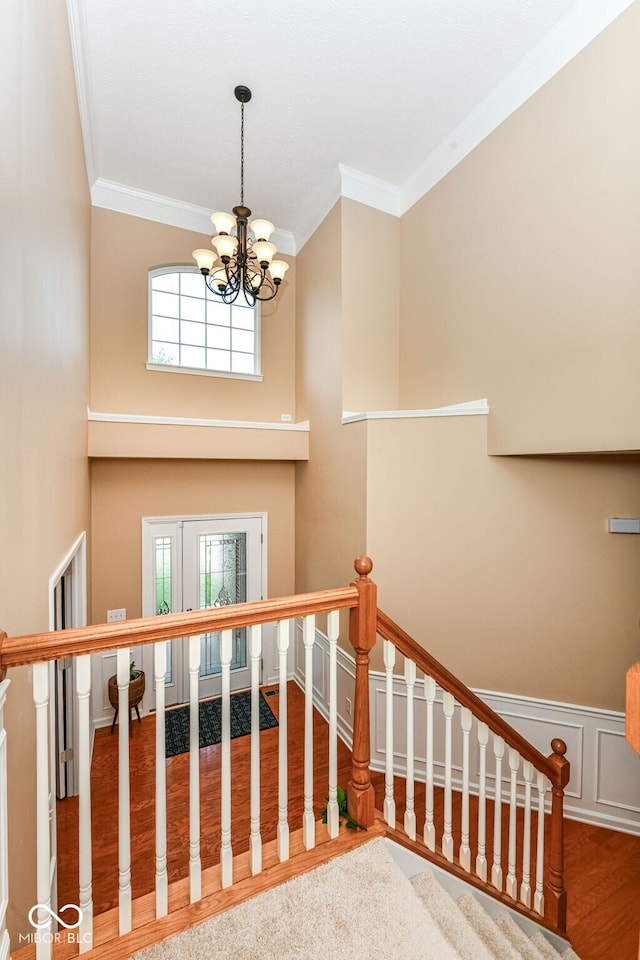 13700 Stanford Dr, Carmel, IN 46074 - stairs with a chandelier, crown molding, and wood finished floors