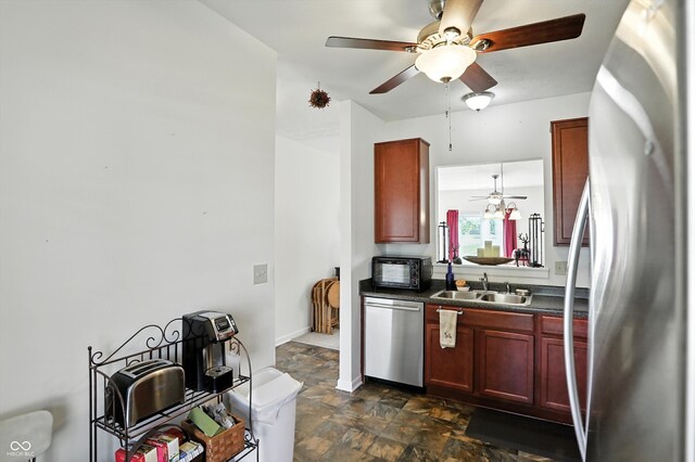 2253 Bridlewood Dr, Franklin, IN 46131 - kitchen featuring stainless steel appliances, dark countertops, reddish brown cabinets, ceiling fan, and stone finish flooring
