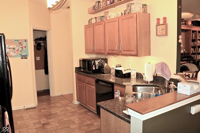 650 S Eagles Way, Crawfordsville, IN 47933 - kitchen with black appliances, stone finish floors, a peninsula, light brown cabinets, and dark stone countertops
