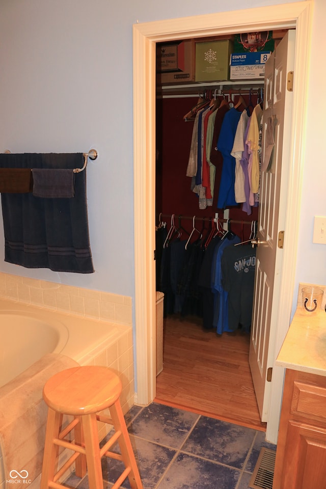 650 S Eagles Way, Crawfordsville, IN 47933 - bathroom featuring a tub, vanity, and a walk in closet