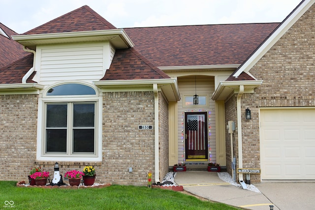 650 S Eagles Way, Crawfordsville, IN 47933 - entrance to property featuring a shingled roof, an attached garage, and brick siding
