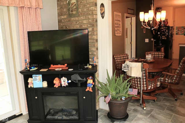 650 S Eagles Way, Crawfordsville, IN 47933 - living room featuring a glass covered fireplace, a chandelier, and tile patterned flooring