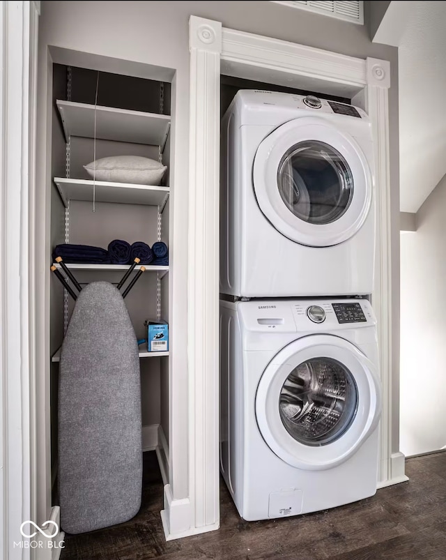 213 E 15th St, Indianapolis, IN 46202 - laundry room featuring stacked washer and clothes dryer and dark wood-style flooring