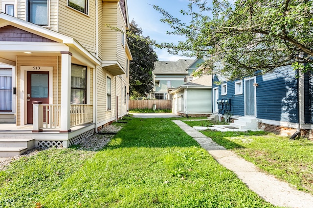 213 E 15th St, Indianapolis, IN 46202 - view of grassy yard with entry steps, an outdoor structure, and a residential view
