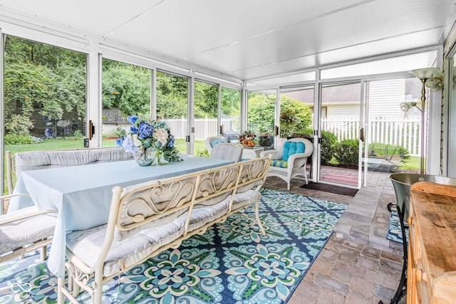 6439 Bower Dr, Indianapolis, IN 46241 - sunroom with stone tile flooring, an outdoor hangout area, and outdoor dining area