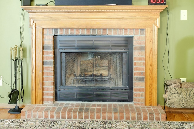 6439 Bower Dr, Indianapolis, IN 46241 - detailed view of a brick fireplace and wood finished floors