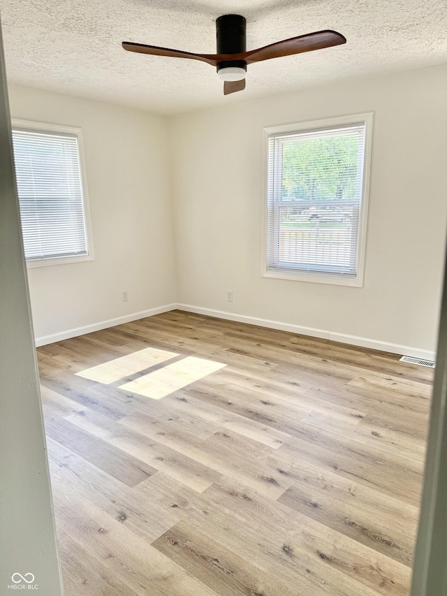405 E Cowing Dr, Muncie, IN 47303 - unfurnished room with wood finished floors, a ceiling fan, and a textured ceiling
