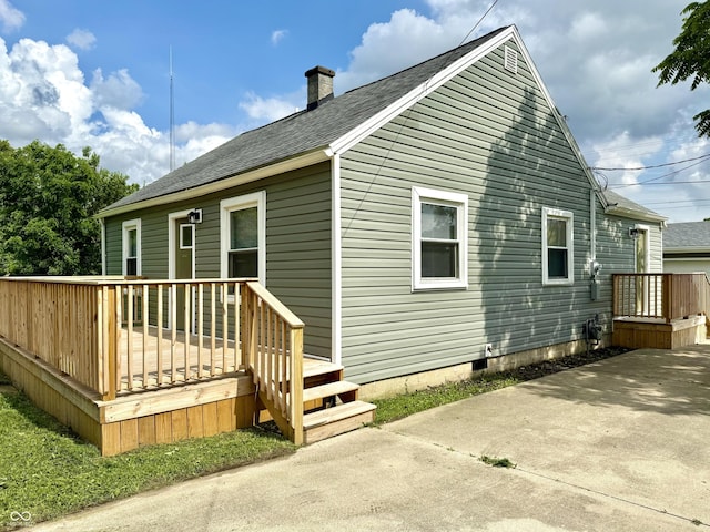 405 E Cowing Dr, Muncie, IN 47303 - back of property featuring a chimney, a deck, and a shingled roof