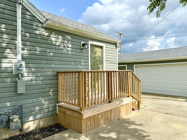 405 E Cowing Dr, Muncie, IN 47303 - wooden deck featuring a garage and driveway
