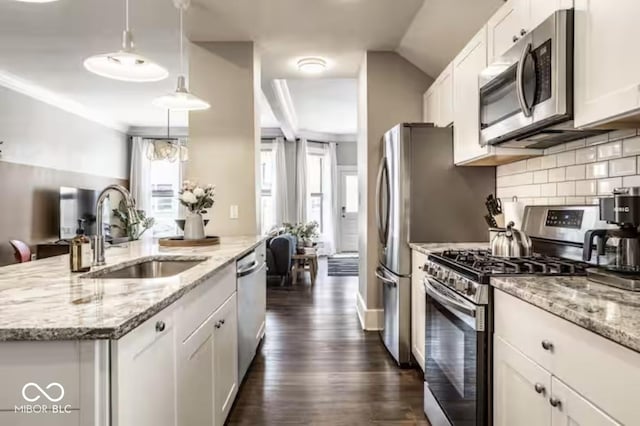 215 E 15th St, Indianapolis, IN 46202 - kitchen featuring stainless steel appliances, white cabinetry, decorative backsplash, an island with sink, and dark wood-type flooring