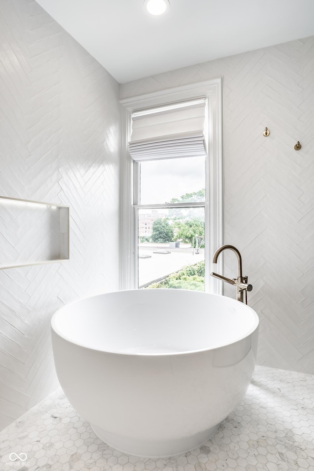214 E St Joseph St, Indianapolis, IN 46202 - bathroom featuring a soaking tub and tile patterned floors