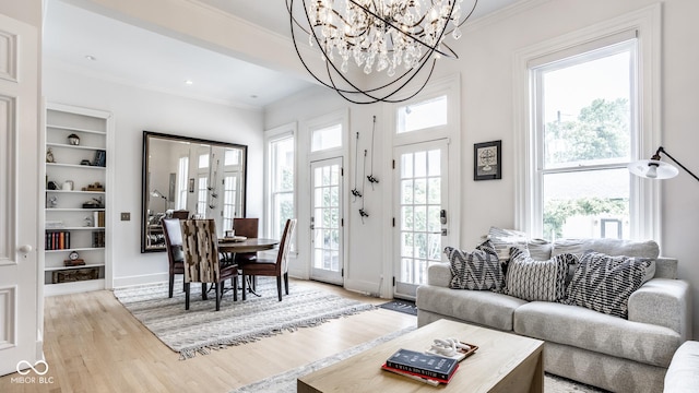 214 E St Joseph St, Indianapolis, IN 46202 - living area with light wood finished floors, crown molding, a chandelier, and built in features