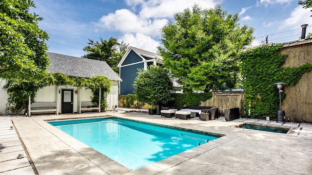 214 E St Joseph St, Indianapolis, IN 46202 - view of swimming pool featuring outdoor lounge area, an outbuilding, an in-ground hot tub, and a patio