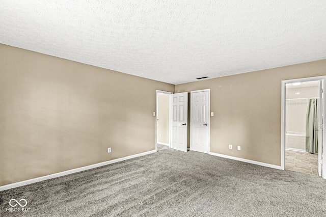 1540 Brook Pointe Dr, Indianapolis, IN 46234 - unfurnished bedroom with carpet floors, a textured ceiling, stainless steel refrigerator, and connected bathroom