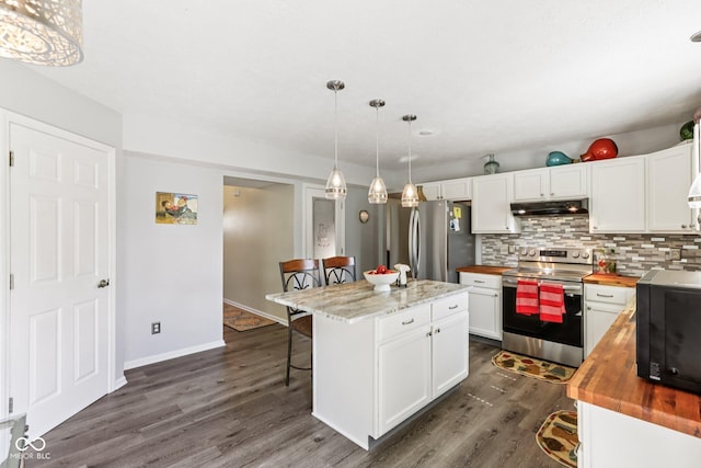 6711 Crestwell Ln, Indianapolis, IN 46268 - kitchen with appliances with stainless steel finishes, butcher block countertops, under cabinet range hood, a kitchen bar, and white cabinets