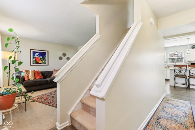 6711 Crestwell Ln, Indianapolis, IN 46268 - stairway with baseboards and wood finished floors