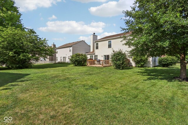 6711 Crestwell Ln, Indianapolis, IN 46268 - view of grassy yard with a deck