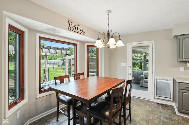 8030 5 Points Rd, Indianapolis, IN 46259 - dining space featuring a chandelier, stone finish floors, and healthy amount of natural light