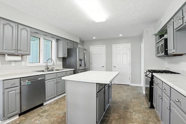 8030 5 Points Rd, Indianapolis, IN 46259 - kitchen with stainless steel appliances, gray cabinets, a textured ceiling, a center island, and light countertops
