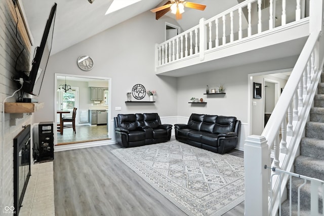 8030 5 Points Rd, Indianapolis, IN 46259 - living area with high vaulted ceiling, wood finished floors, stairway, a glass covered fireplace, and a ceiling fan