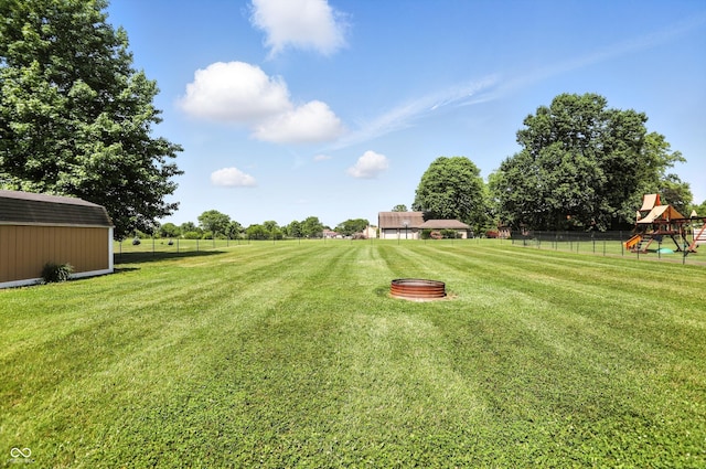 8030 5 Points Rd, Indianapolis, IN 46259 - view of yard with a storage shed and a playground