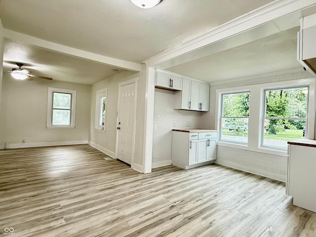 3712 S Kealing Ave S, Indianapolis, IN 46237 - kitchen with light wood-style flooring, white cabinetry, ceiling fan, and open floor plan