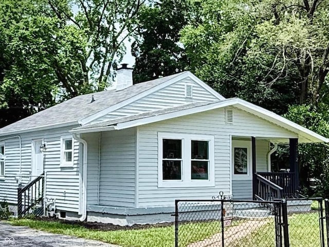3712 S Kealing Ave S, Indianapolis, IN 46237 - view of front of home featuring a chimney, covered porch, a gate, and a shingled roof