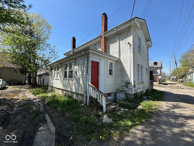 7 N Colorado Ave, Indianapolis, IN 46201 - view of home's exterior featuring entry steps and a chimney