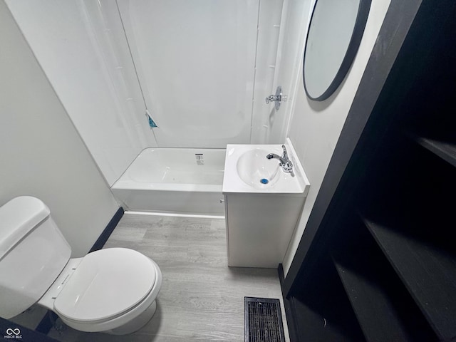1013 E Pike St, Crawfordsville, IN 47933 - full bathroom featuring wood finished floors, vanity, and bathtub / shower combination