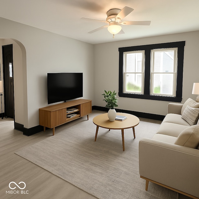 1013 E Pike St, Crawfordsville, IN 47933 - living room with light wood-type flooring, arched walkways, and ceiling fan