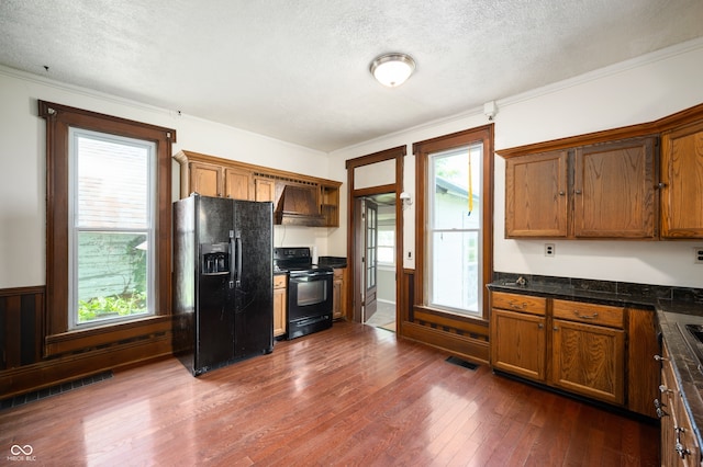 5396 N 1000 E, Sheridan, IN 46069 - kitchen with black appliances, a textured ceiling, dark countertops, dark wood-type flooring, and brown cabinetry