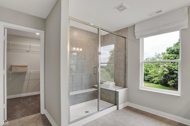 5343 Pelion Pl, Mccordsville, IN 46055 - bathroom featuring healthy amount of natural light, a shower stall, tile patterned floors, and a spacious closet