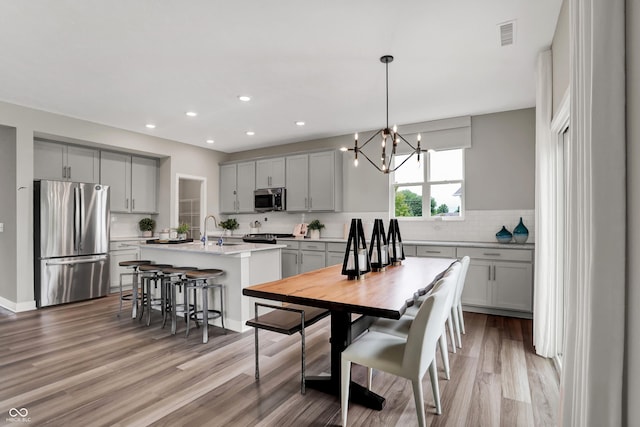 5343 Pelion Pl, Mccordsville, IN 46055 - dining area with light wood-style floors, a chandelier, and recessed lighting