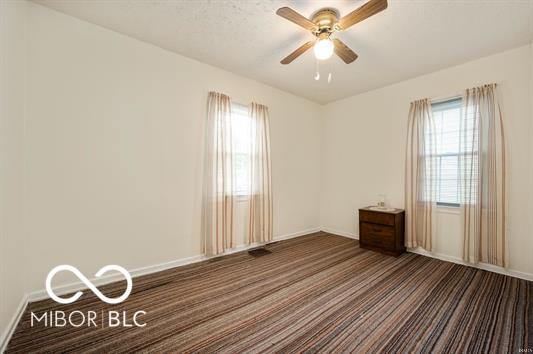 2410 S Ebright St, Muncie, IN 47302 - spare room featuring carpet floors and a ceiling fan