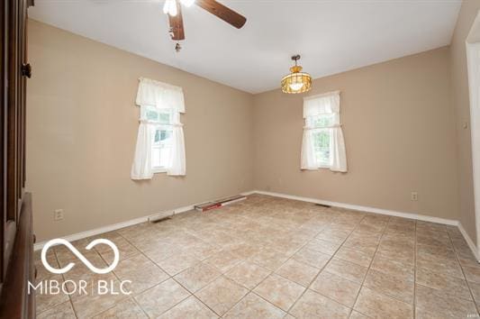 2410 S Ebright St, Muncie, IN 47302 - empty room with plenty of natural light, a ceiling fan, and light tile patterned floors