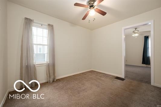 2410 S Ebright St, Muncie, IN 47302 - carpeted empty room with baseboards and ceiling fan