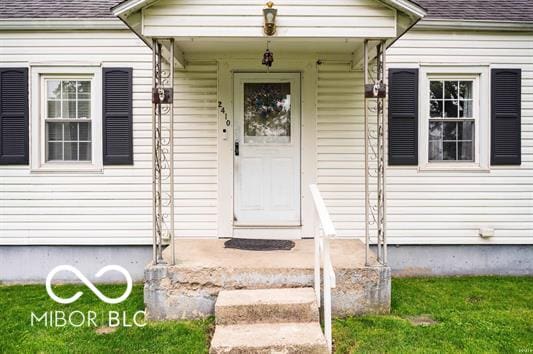 2410 S Ebright St, Muncie, IN 47302 - doorway to property featuring a shingled roof