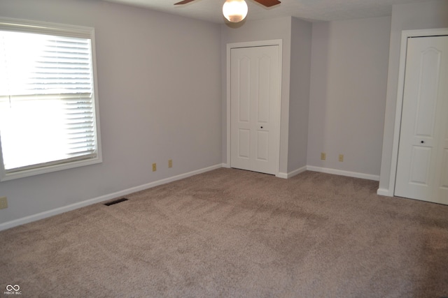 112 Marble Arch Way, Lafayette, IN 47905 - unfurnished bedroom featuring carpet flooring, ceiling fan, and two closets
